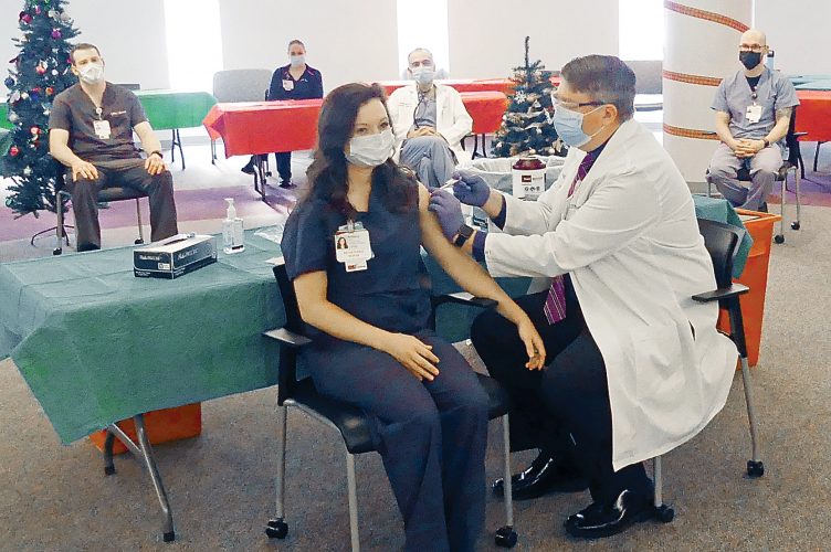 Frontline workers get first vaccines